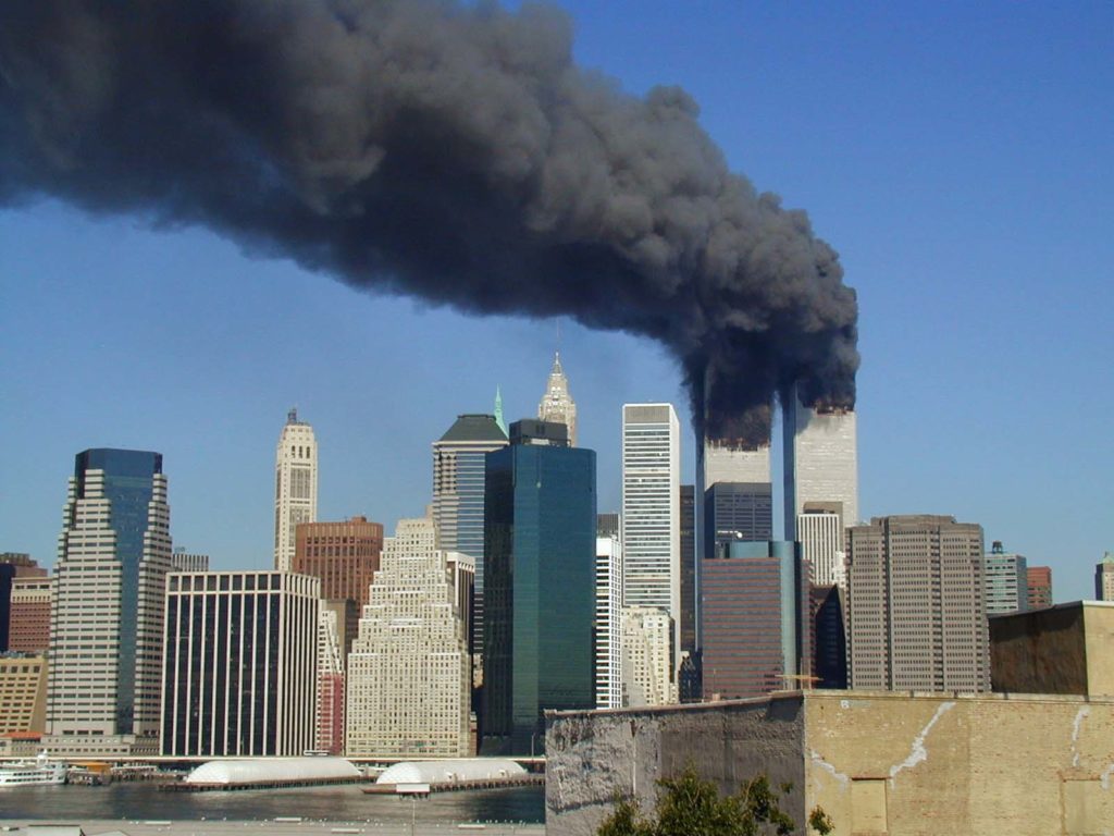 Photo Source: https://commons.wikimedia.org/wiki/File:WTC_smoking_on_9-11.jpeg